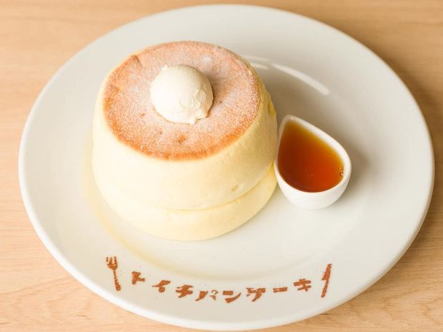 Signature soufflé pancakes with whipped butter and maple syrup